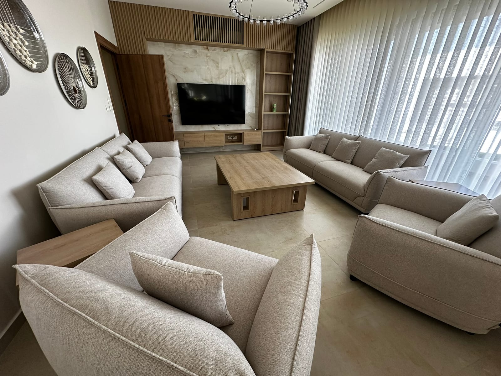Living room with custom wood millwork by Al Reem