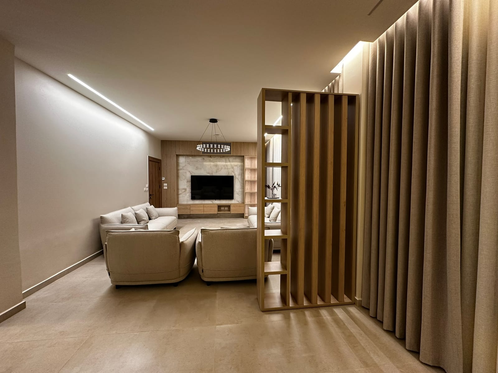 Custom TV wall unit and wood detailing by Al Reem